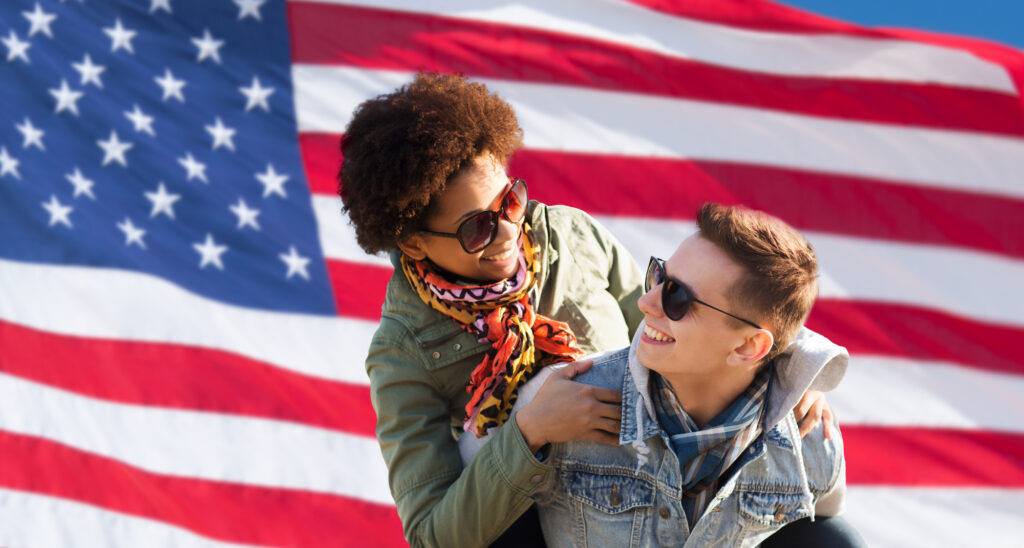 Happy interracial couple over American flag